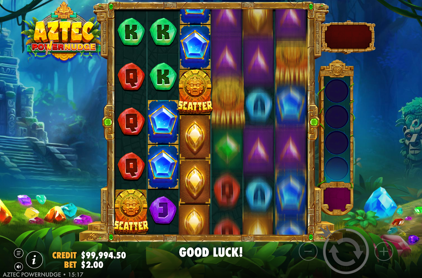 Aztec Powernudge showing two gold sun-god idol SCATTER symbols landing during a spin with the reels mid-nudge and the scatter-collection tube on the right rail